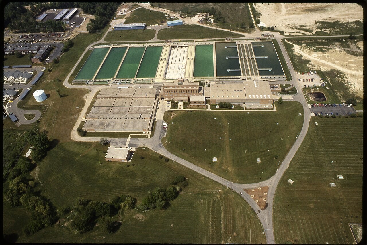 High-angle aerial view of the Hap Cremean Water Plant complex showing extensive rectangular water treatment basins, filtration buildings, and surrounding grounds.