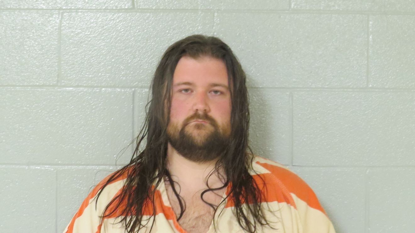 Law enforcement booking photograph of Zachary Robert Hammons in a jail uniform.