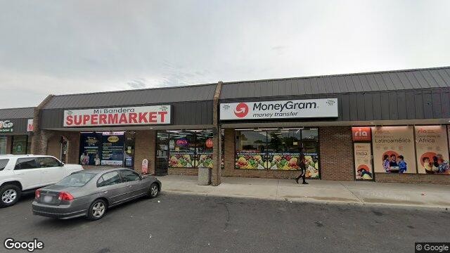 Street-level exterior view of the Mi Bandera Supermarket storefront and entrance along East Dublin-Granville Road.