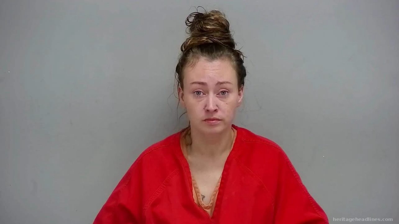 Head-and-shoulders booking photo of Brittany M. Stroud wearing an orange inmate uniform against a gray wall.