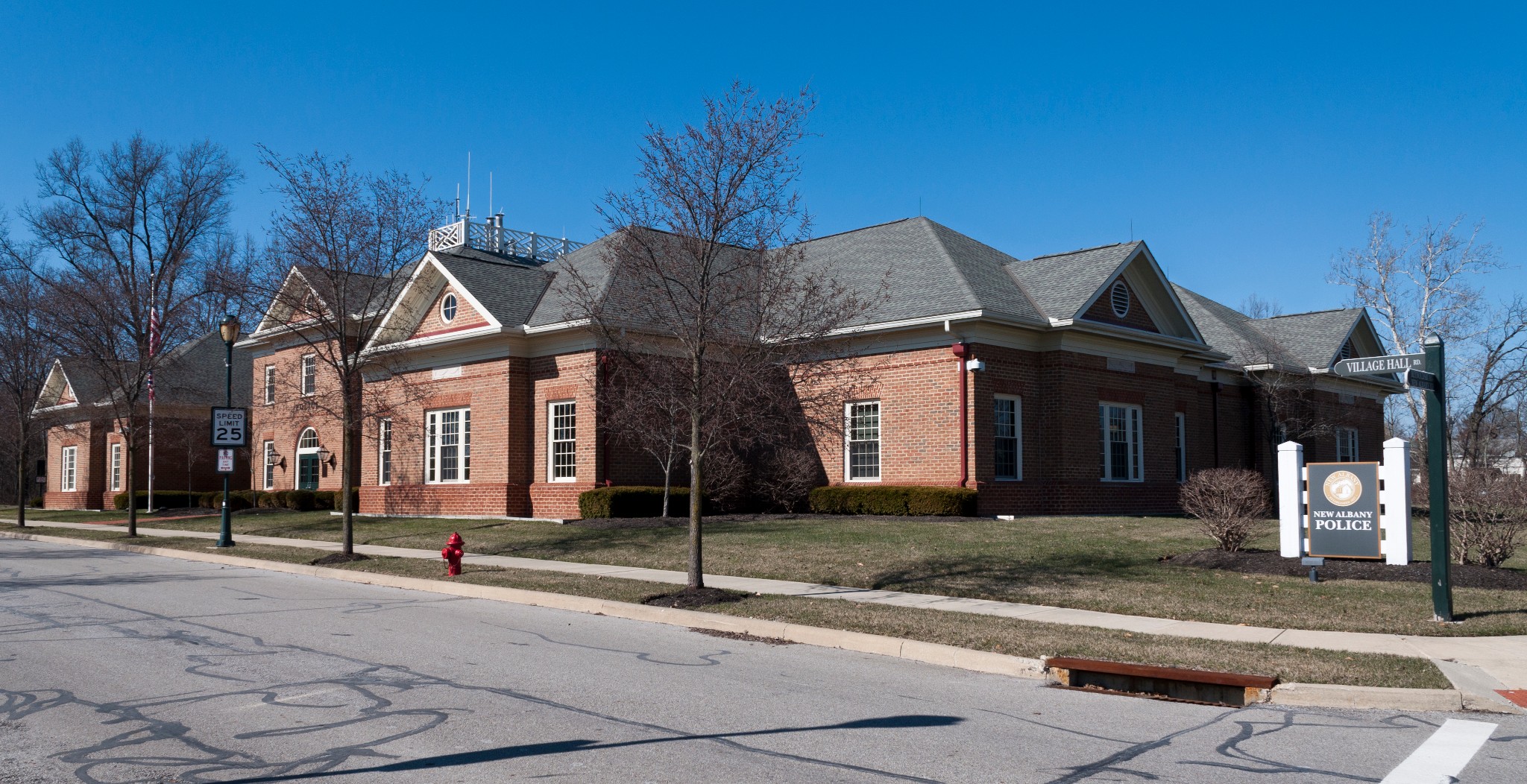 Exterior view of the New Albany Police Department brick headquarters building with signage.