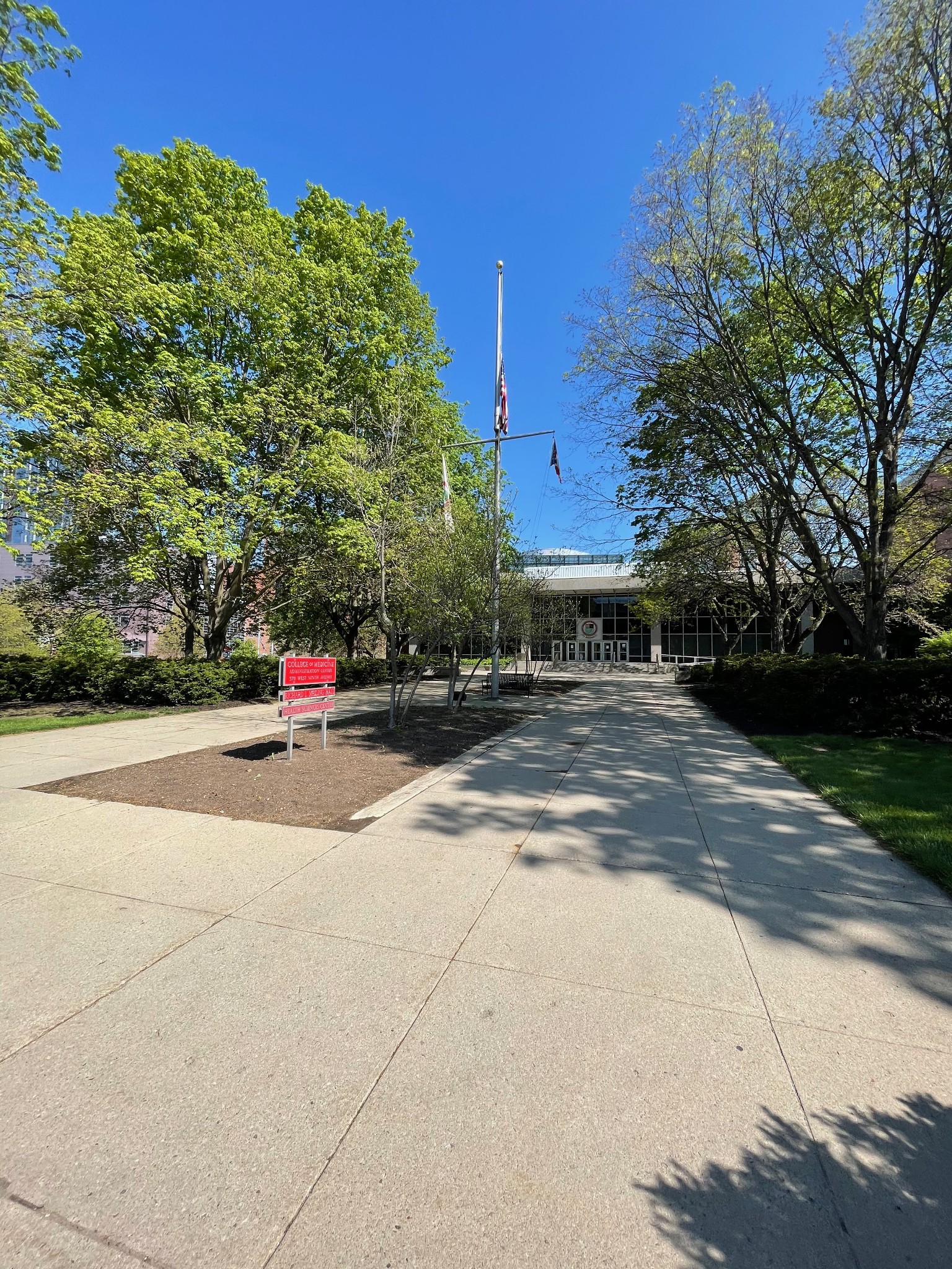Paved campus path leading to Meiling Hall at Ohio State University, with a red directory sign for the College of Medicine Administration Center on the left.