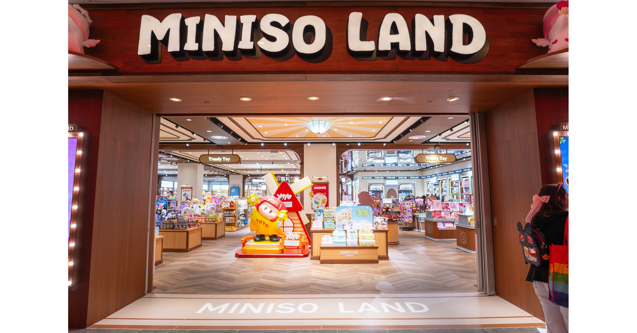 Storefront entrance to MINISO LAND at Easton Town Center in Columbus, Ohio, featuring illuminated 3D signage and a large YOYO character statue.