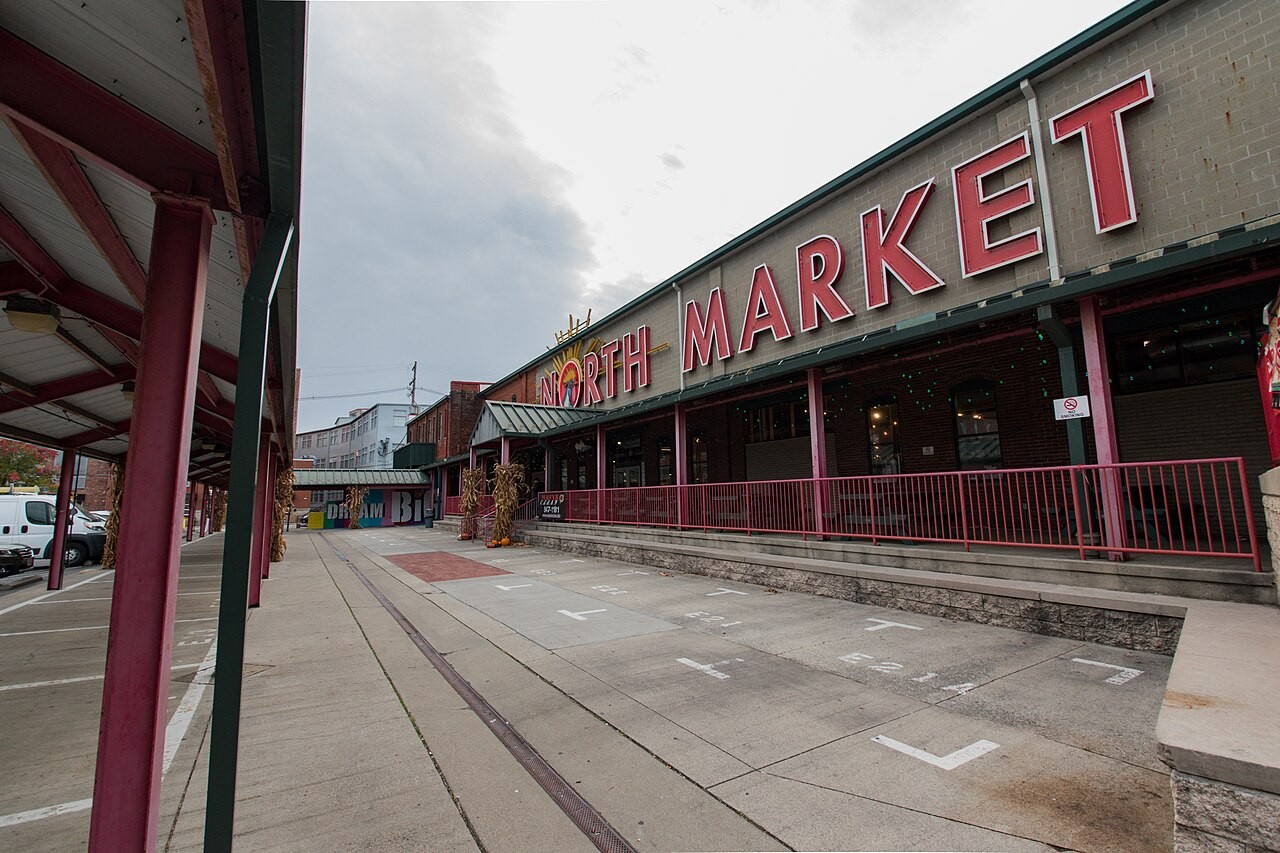 Exterior perspective along North Market at 59 Spruce Street in Columbus showing prominent large red letters spelling NORTH MARKET above the porch walkway.