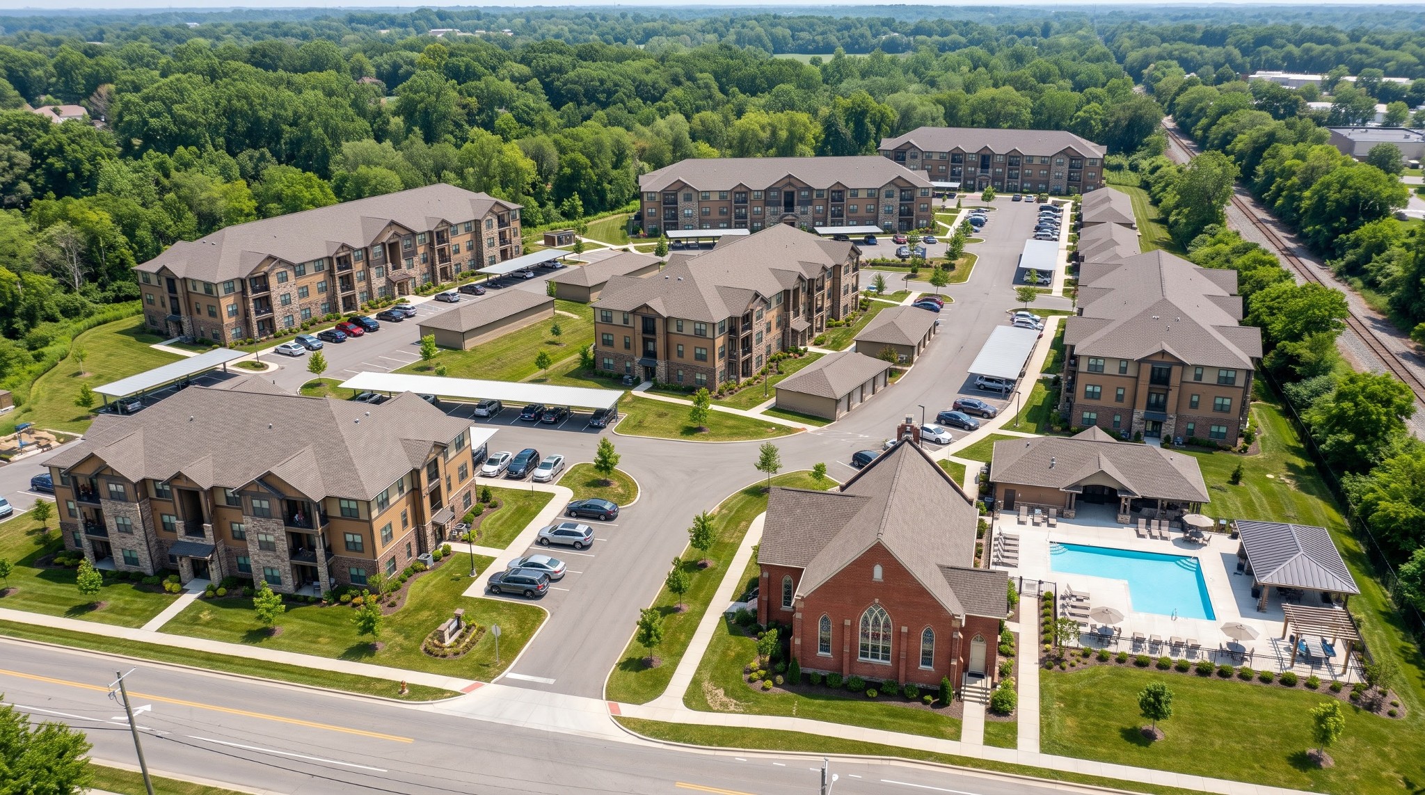 Conceptual aerial rendering of the proposed Linworth Apartments development showing apartment buildings, parking areas and the historic brick church building.
