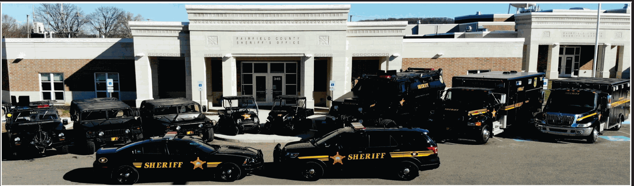 Fairfield County Sheriff patrol cruisers and vehicles parked outside the agency's headquarters building.