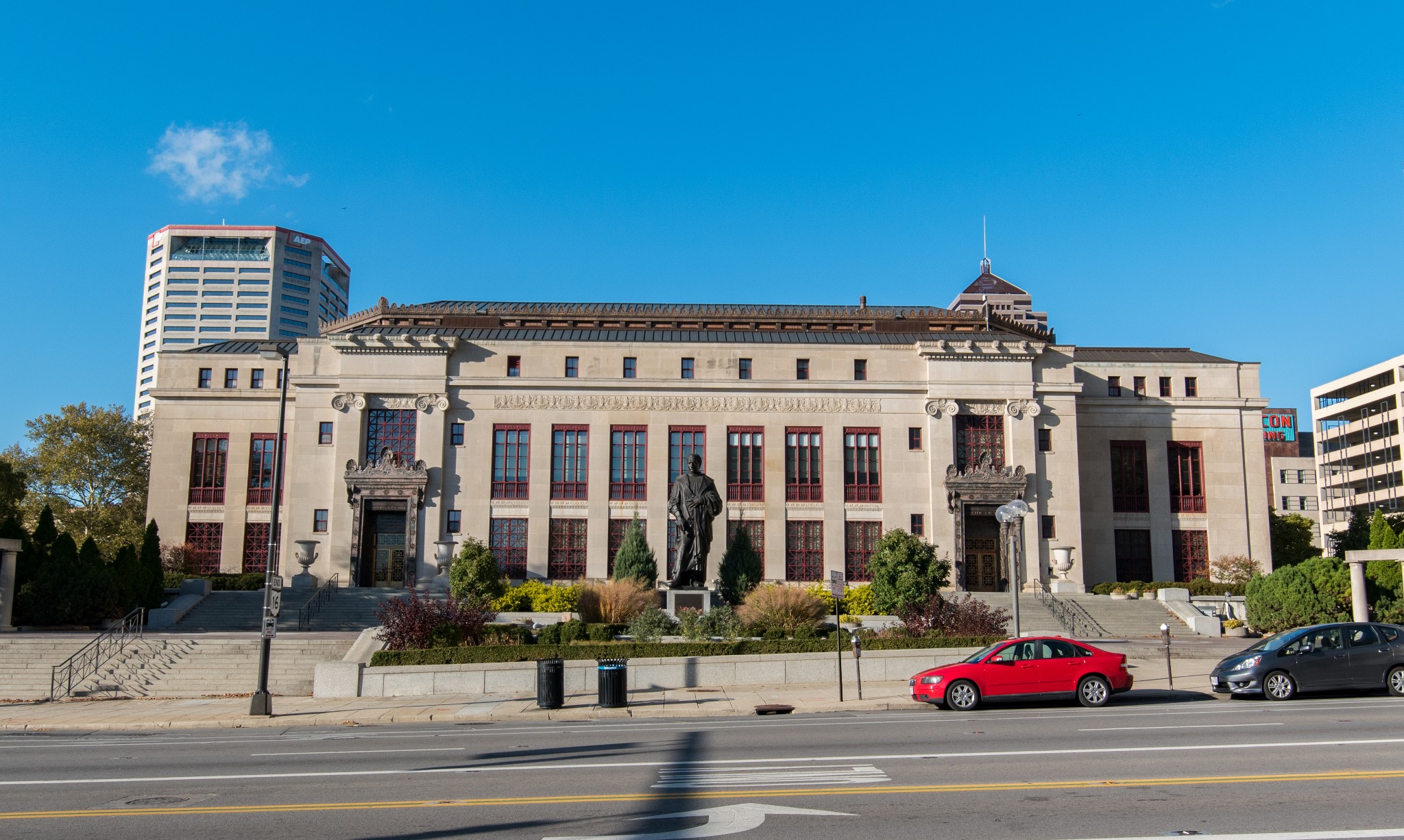 Neoclassical exterior limestone facade of Columbus City Hall under a clear blue sky.